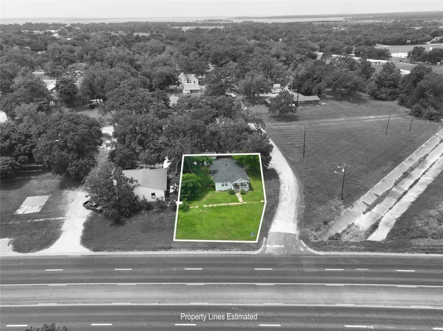 an aerial view of a house with a yard