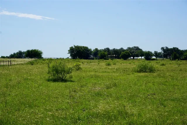 a view of a lake with houses in the background