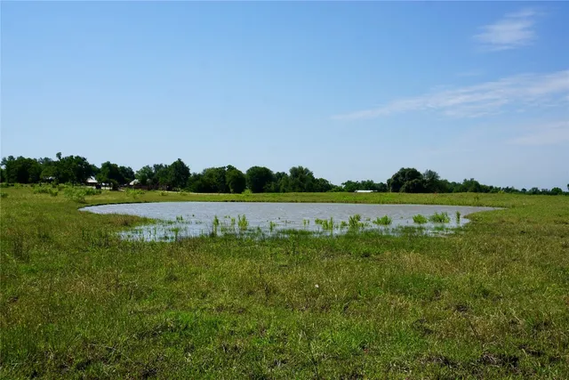a view of a lake with houses in the back