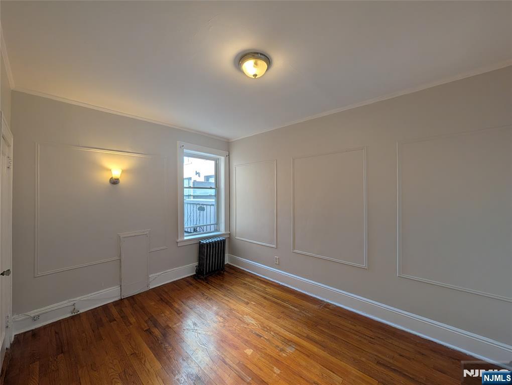 85 Anderson Street, Unit C5 Hackensack, NJ 07601 - Photo 2 of 6 a view of empty room with wooden floor and fan