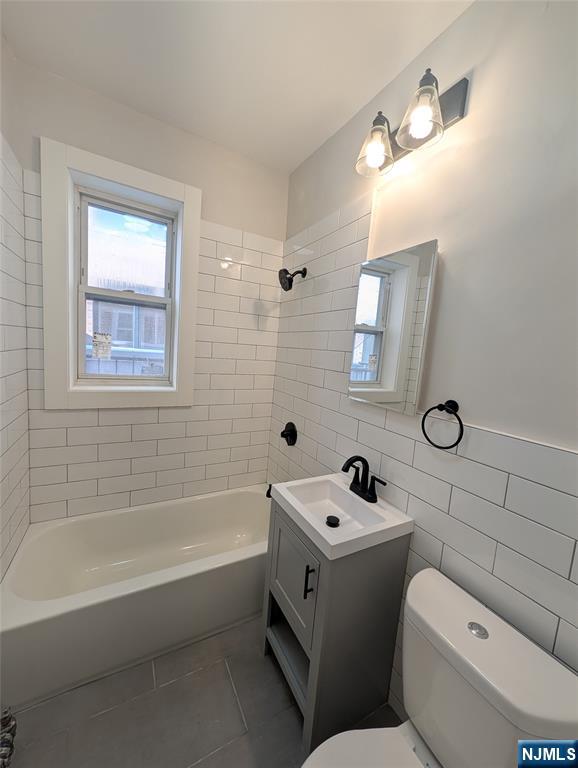 85 Anderson Street, Unit C5 Hackensack, NJ 07601 - Photo 5 of 6 a bathroom with a sink a toilet and shower