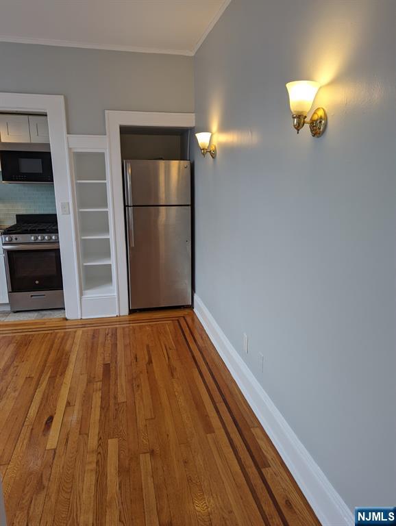 85 Anderson Street, Unit C6 Hackensack, NJ 07601 - Photo 5 of 8 a view of a room with wooden floor staircase and a kitchen space