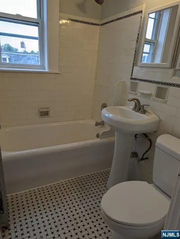 a bathroom with a toilet and a bathtub
