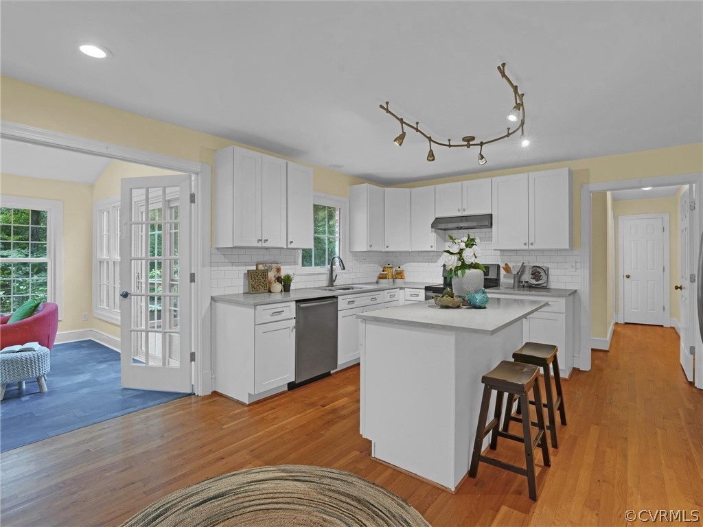 12100 2nd Branch Road Chesterfield, VA 23838 - Photo 11 of 41 a kitchen with white cabinets and wooden floor