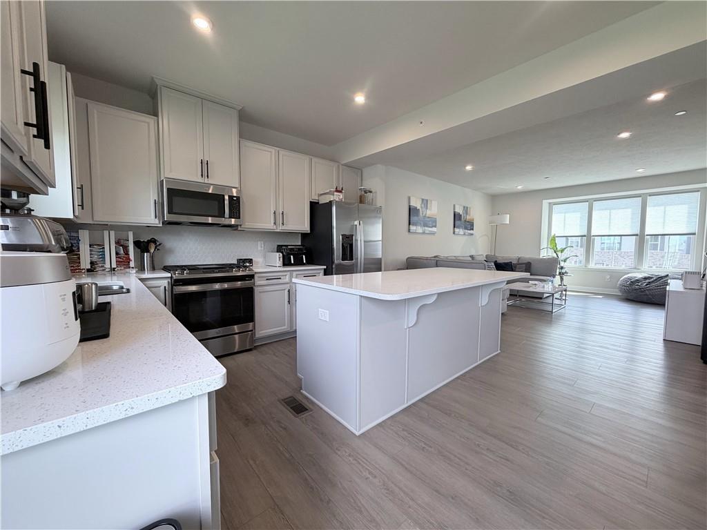 120 Crown Street McKees Rocks, PA 15136 - Photo 7 of 28 a large kitchen with stainless steel appliances lots of counter space sink and a refrigerator