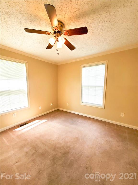 602 Self Street Cherryville, NC 28021 - Photo 12 of 22 an empty room with windows and fan