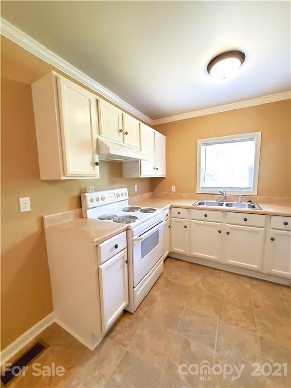 602 Self Street Cherryville, NC 28021 - Photo 13 of 22 a kitchen with granite countertop white cabinets and white appliances