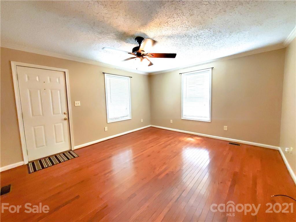 602 Self Street Cherryville, NC 28021 - Photo 5 of 22 wooden floor in an empty room with a window