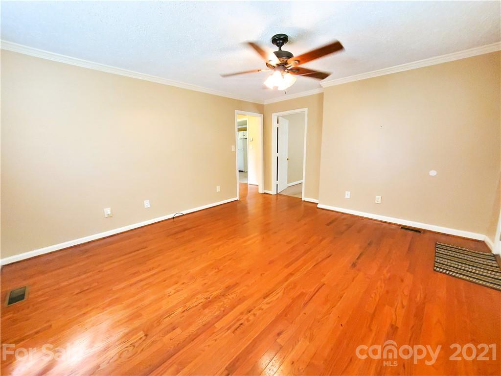 602 Self Street Cherryville, NC 28021 - Photo 7 of 22 a view of a big room with wooden floor and a ceiling fan