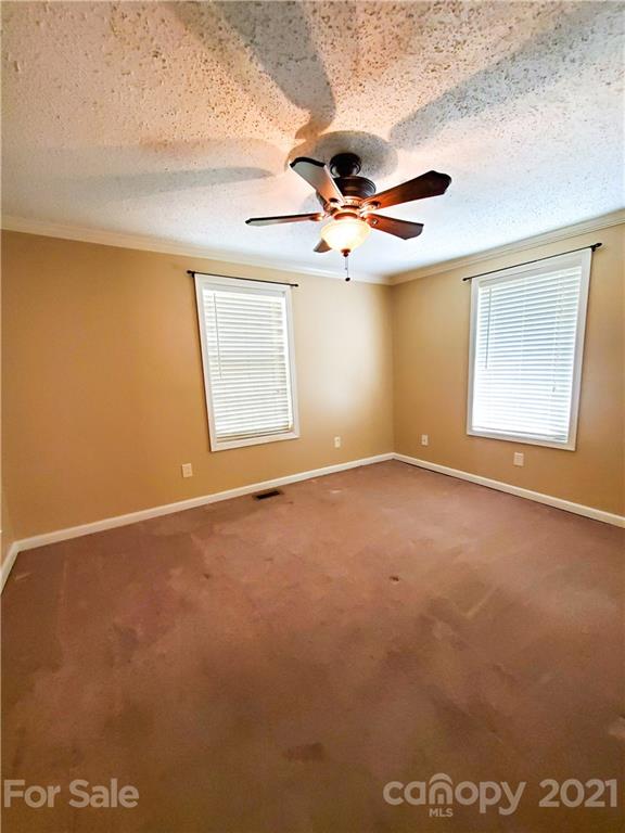 602 Self Street Cherryville, NC 28021 - Photo 9 of 22 an empty room with windows and fan