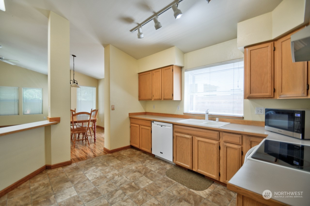 4530 Beckonridge Loop Southeast Lacey, WA 98513 - Photo 11 of 28 a kitchen with lots of counter top space and dining table