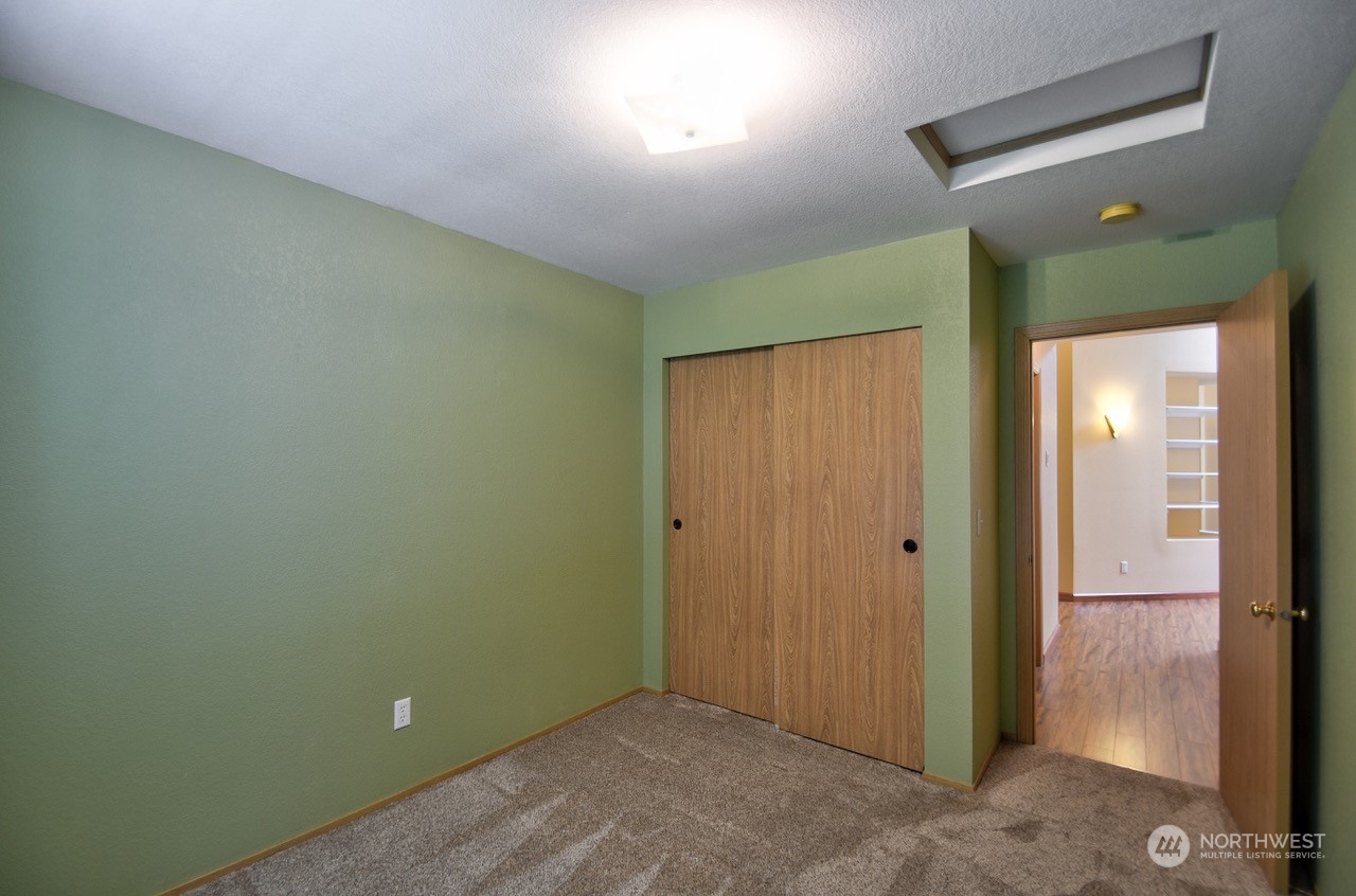 4530 Beckonridge Loop Southeast Lacey, WA 98513 - Photo 19 of 28 an empty room with closet and mirror