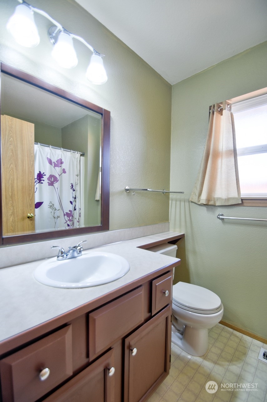 4530 Beckonridge Loop Southeast Lacey, WA 98513 - Photo 21 of 28 a bathroom with a sink a toilet and mirror