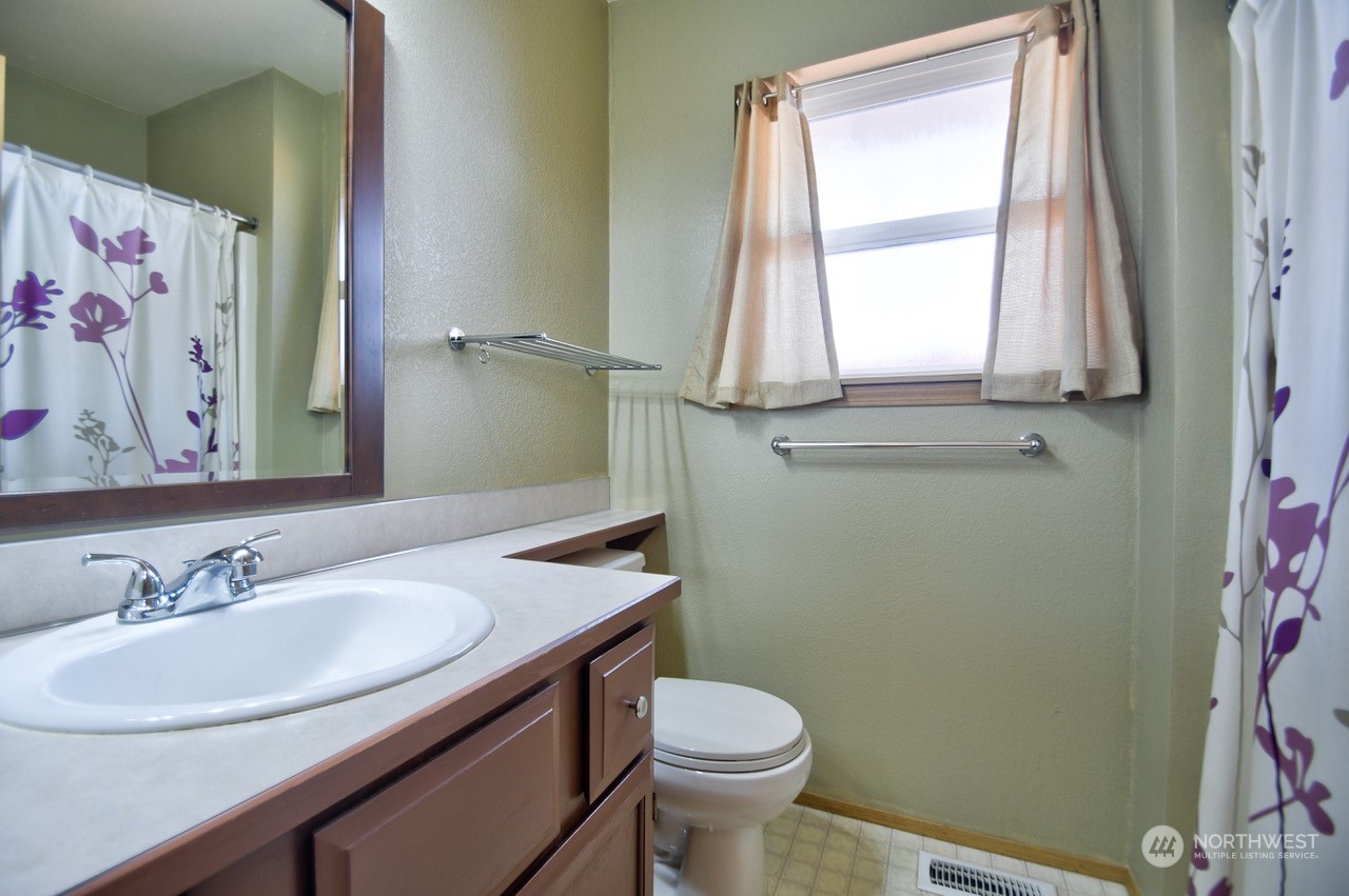 4530 Beckonridge Loop Southeast Lacey, WA 98513 - Photo 22 of 28 a bathroom with a sink vanity mirror and toilet