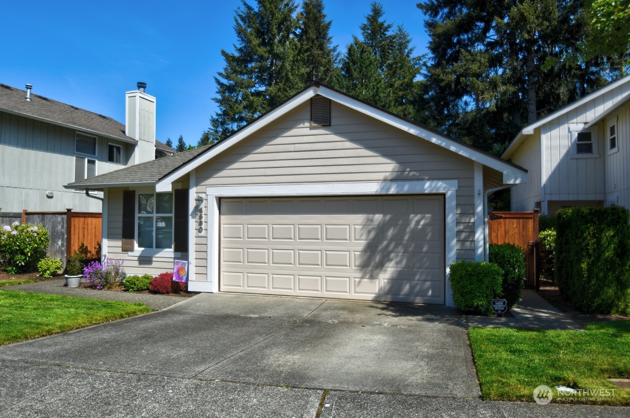 4530 Beckonridge Loop Southeast Lacey, WA 98513 - Photo 27 of 28 a front view of a house with a yard and garage