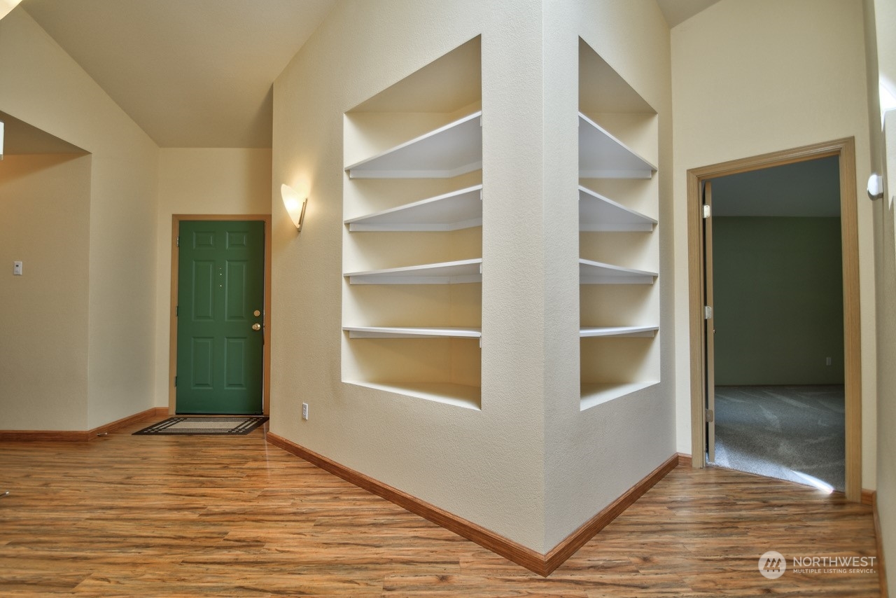 4530 Beckonridge Loop Southeast Lacey, WA 98513 - Photo 3 of 28 a view of an empty room with wooden floor and a window