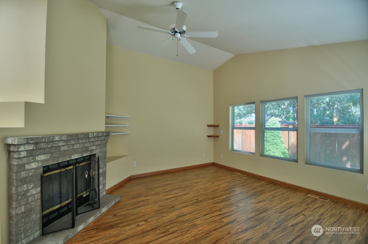 4530 Beckonridge Loop Southeast Lacey, WA 98513 - Photo 5 of 28 a view of an empty room with a fireplace and a window