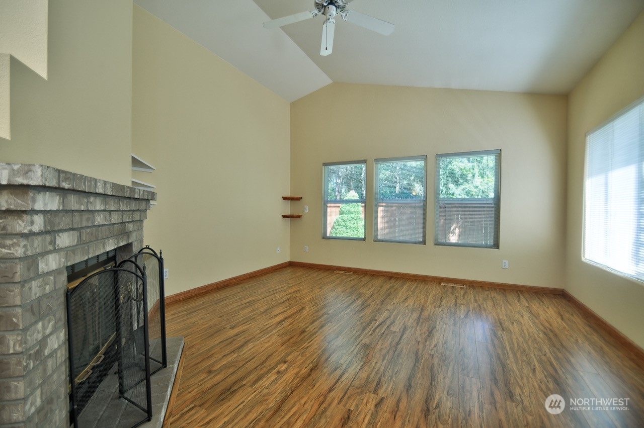 4530 Beckonridge Loop Southeast Lacey, WA 98513 - Photo 6 of 28 an empty room with wooden floor and windows