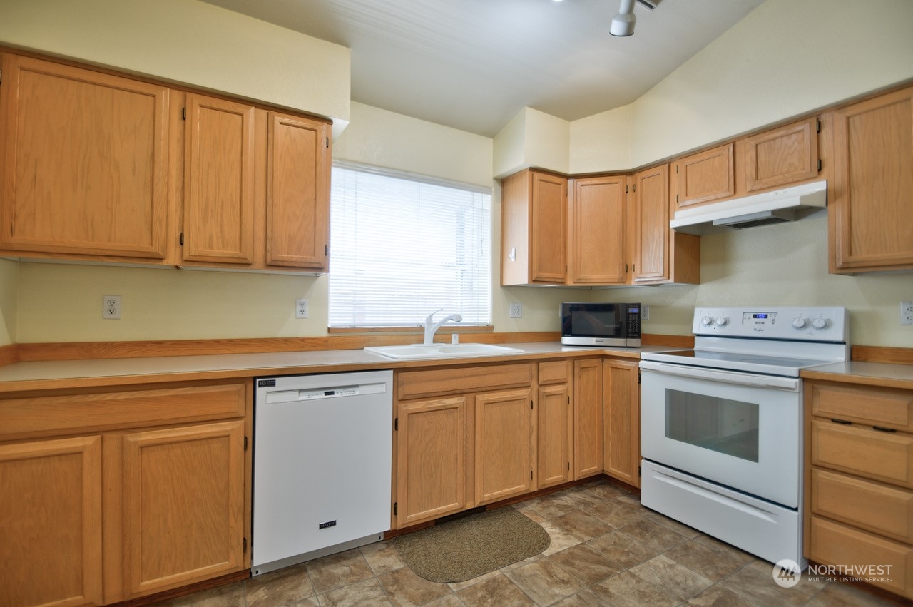 4530 Beckonridge Loop Southeast Lacey, WA 98513 - Photo 10 of 28 a kitchen with white cabinets sink and appliances