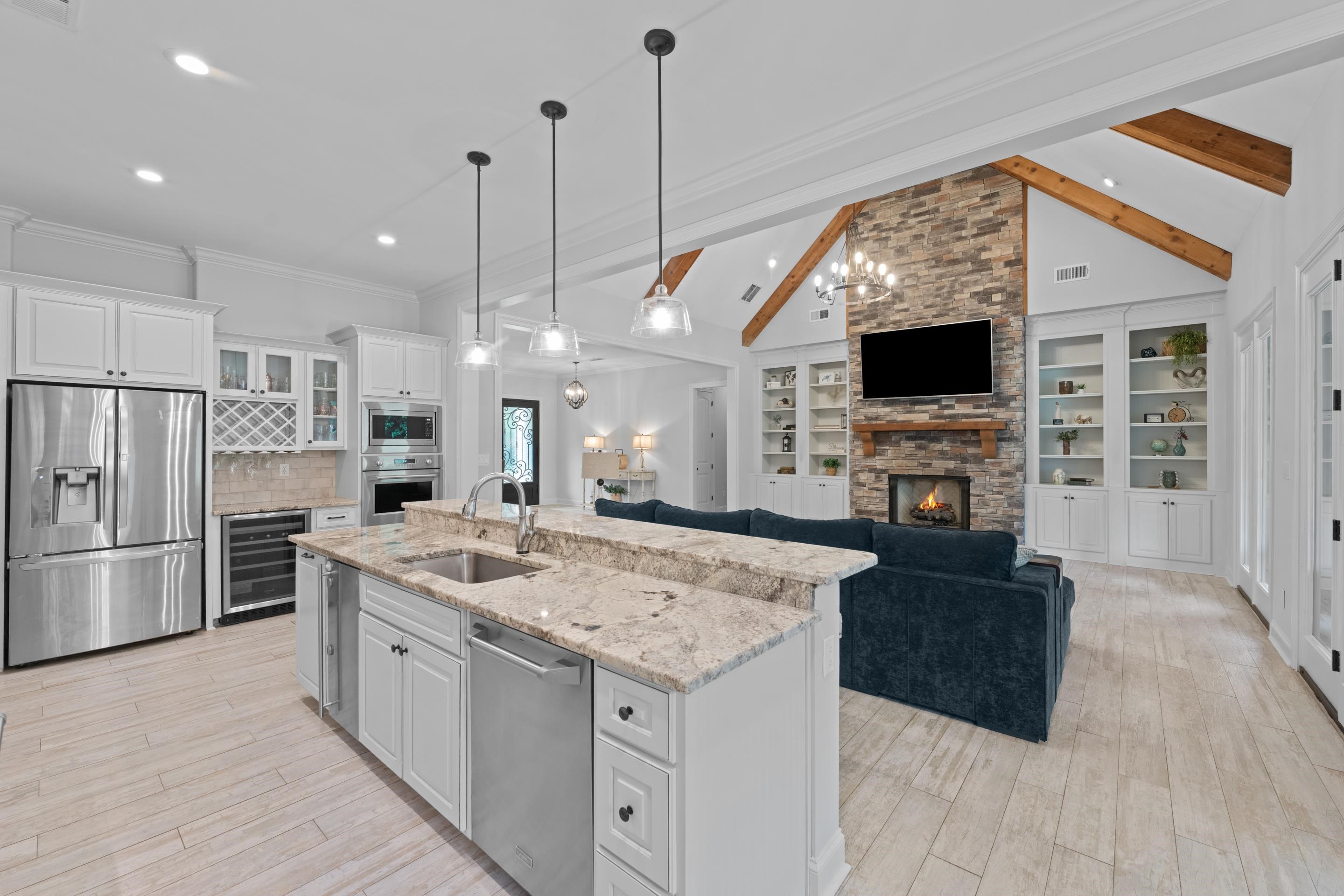 10354 Pleasant Ridge Road Arlington, TN 38002 - Photo 8 of 40 From the kitchen, enjoy views into the soaring great room with exposed wood beams, a stunning stone fireplace, and built-in shelving that adds warmth and character.