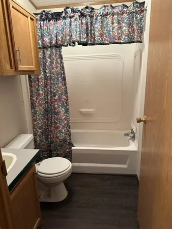 a bathroom with a toilet and a shower