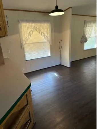 a view of room with window and wooden floor
