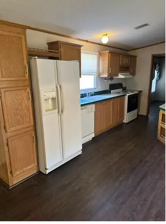 a kitchen with stainless steel appliances a refrigerator and a stove top oven