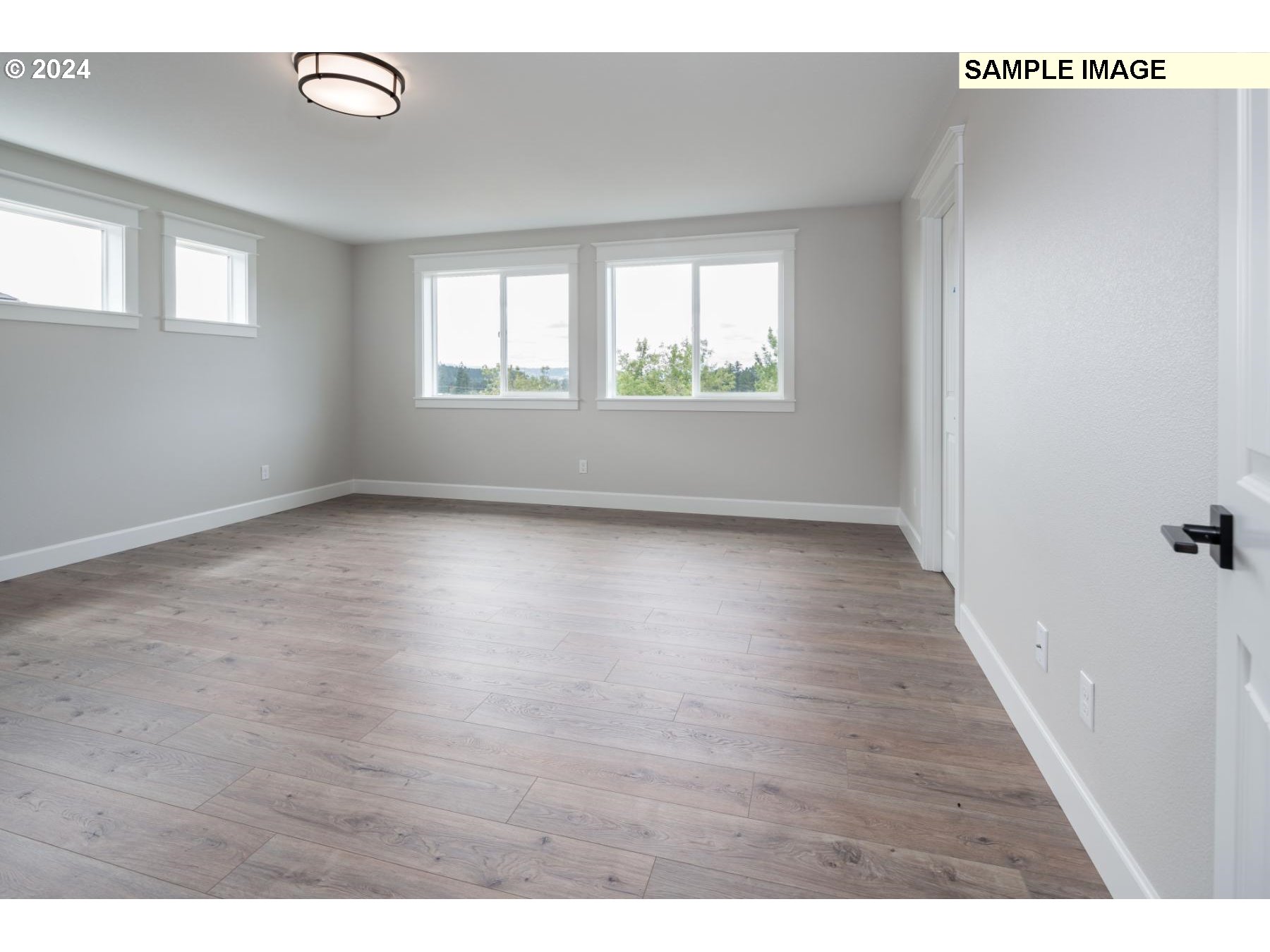 1127 South 46th Place Ridgefield, WA 98642 - Photo 13 of 26 a view of an empty room with wooden floor and a window