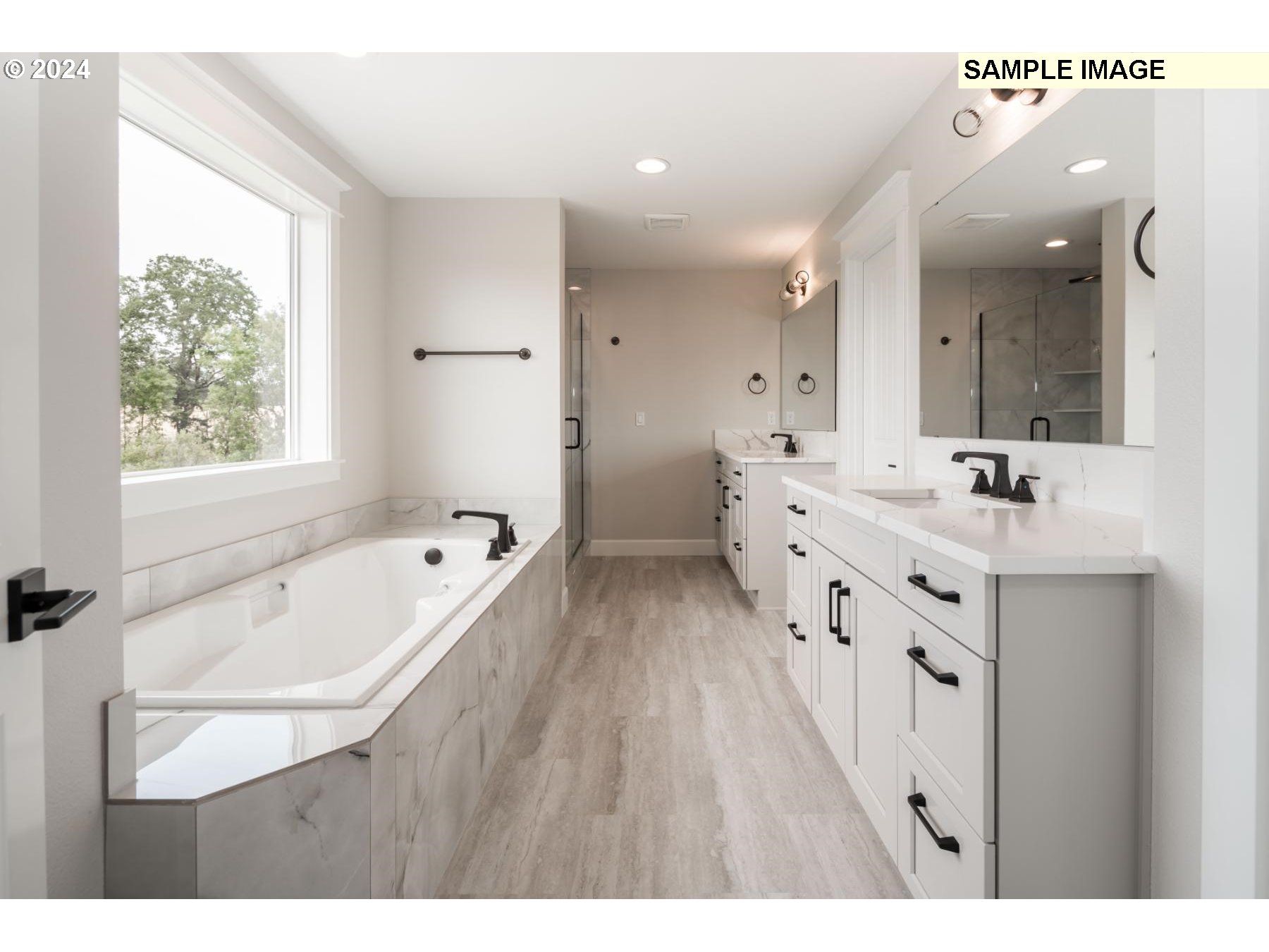 1127 South 46th Place Ridgefield, WA 98642 - Photo 15 of 26 a spacious bathroom with a double vanity sink a mirror and a bathtub