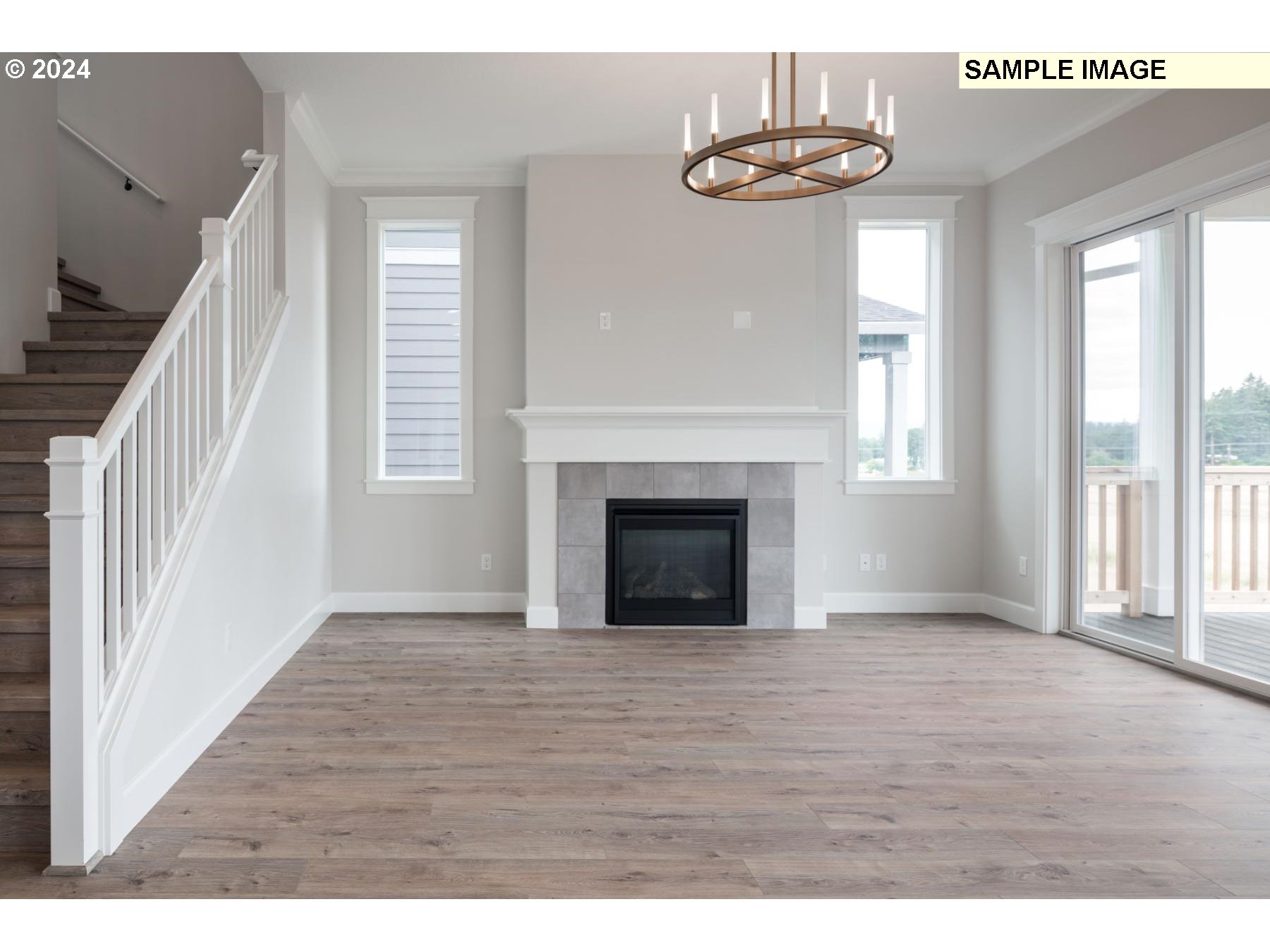 1127 South 46th Place Ridgefield, WA 98642 - Photo 5 of 26 a view of an empty room with wooden floor and a window