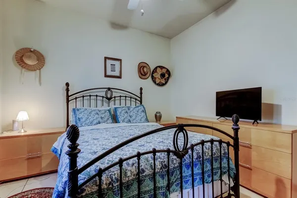 a living room with furniture a chandelier and a flat screen tv