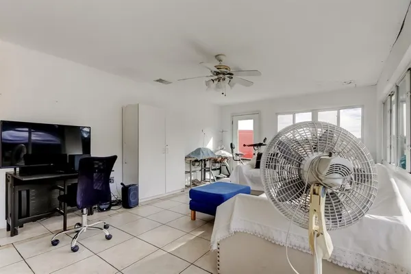 a living room with a bed and a large window