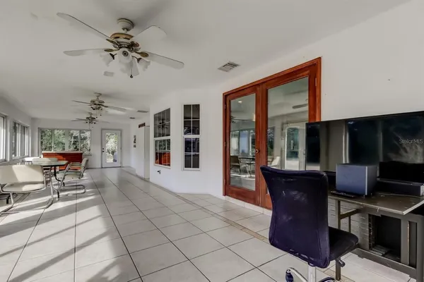 a view of a patio with table and chairs near a barbeque