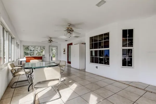 an aerial view of a house with swimming pool table and chairs