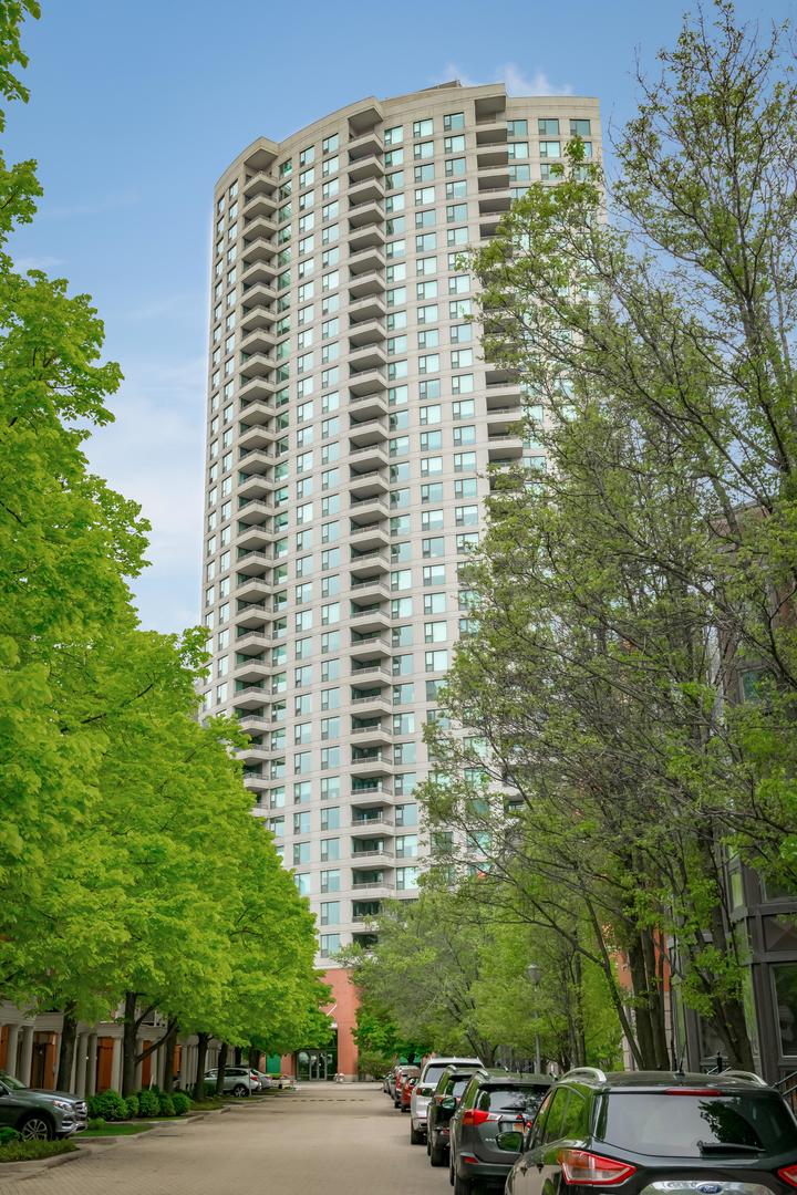 a view of a building and car parked on the roadside