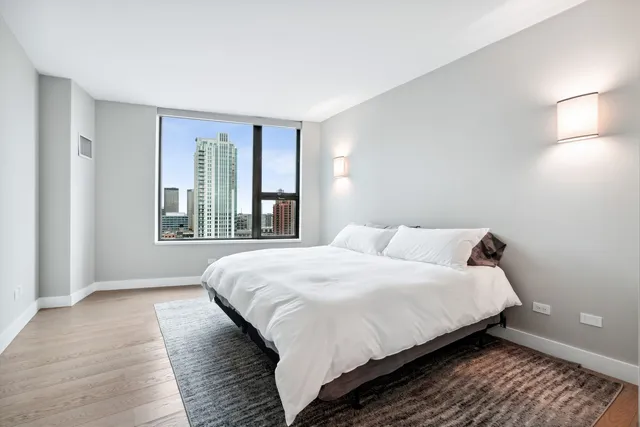 a bedroom with a bed and a window