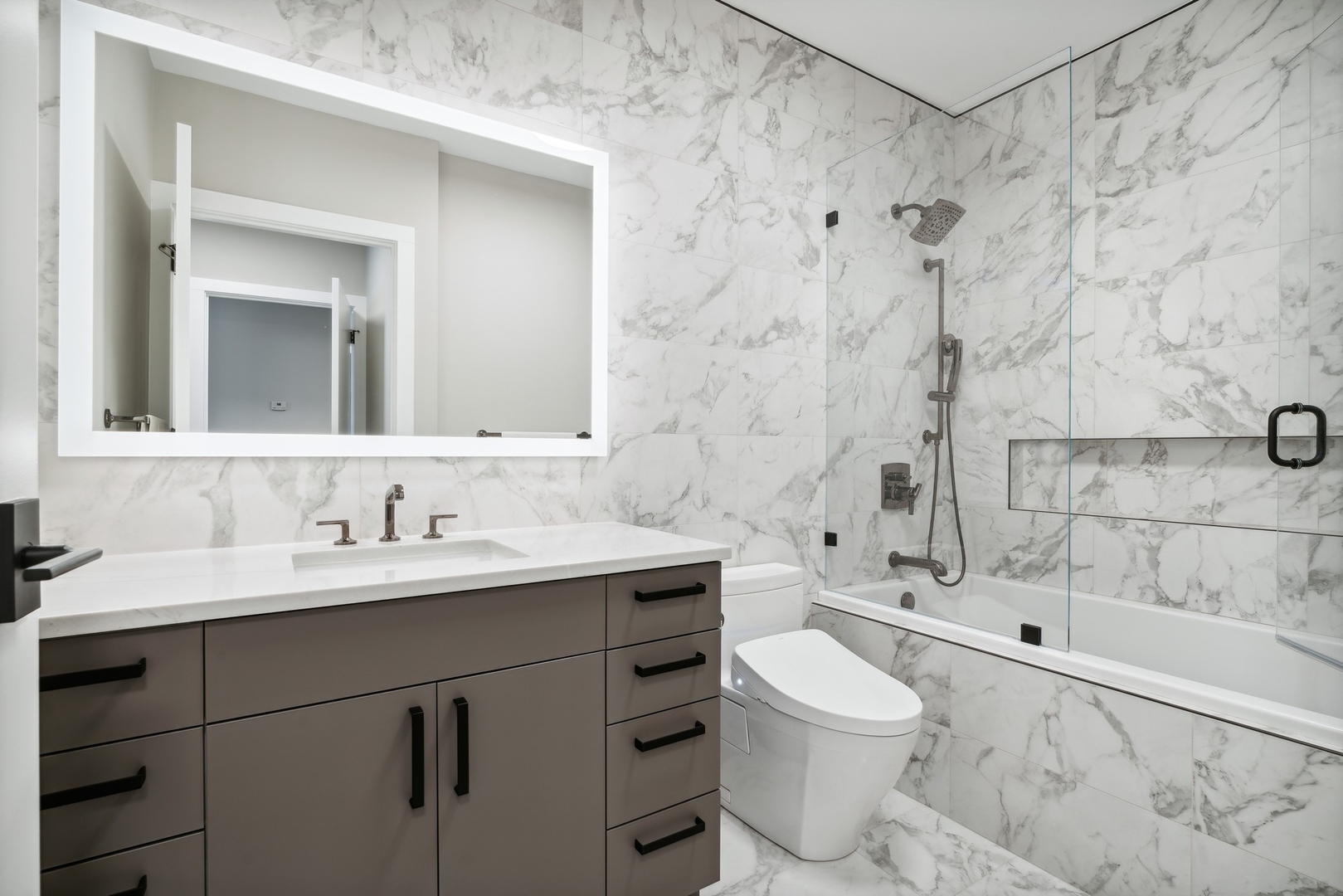 501 North Clinton Street, Unit 2004 Chicago, IL 60654 - Photo 17 of 34 a bathroom with a sink toilet a mirror and shower