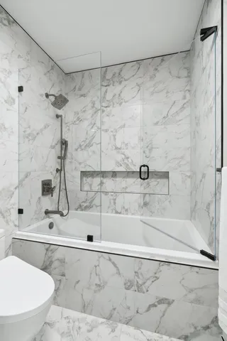 a bathroom with a shower and a toilet