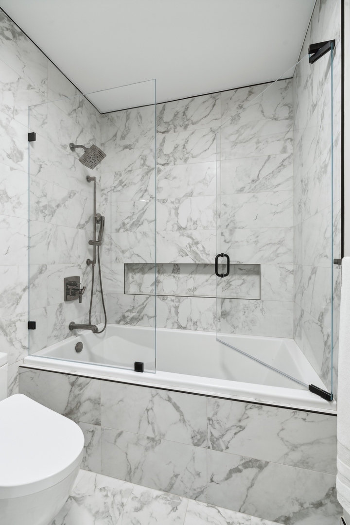 501 North Clinton Street, Unit 2004 Chicago, IL 60654 - Photo 19 of 34 a bathroom with a shower and a toilet