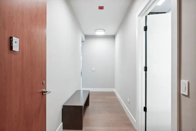 a view of a hallway with wooden floor