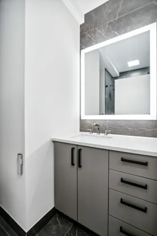 a bathroom with a sink and a mirror