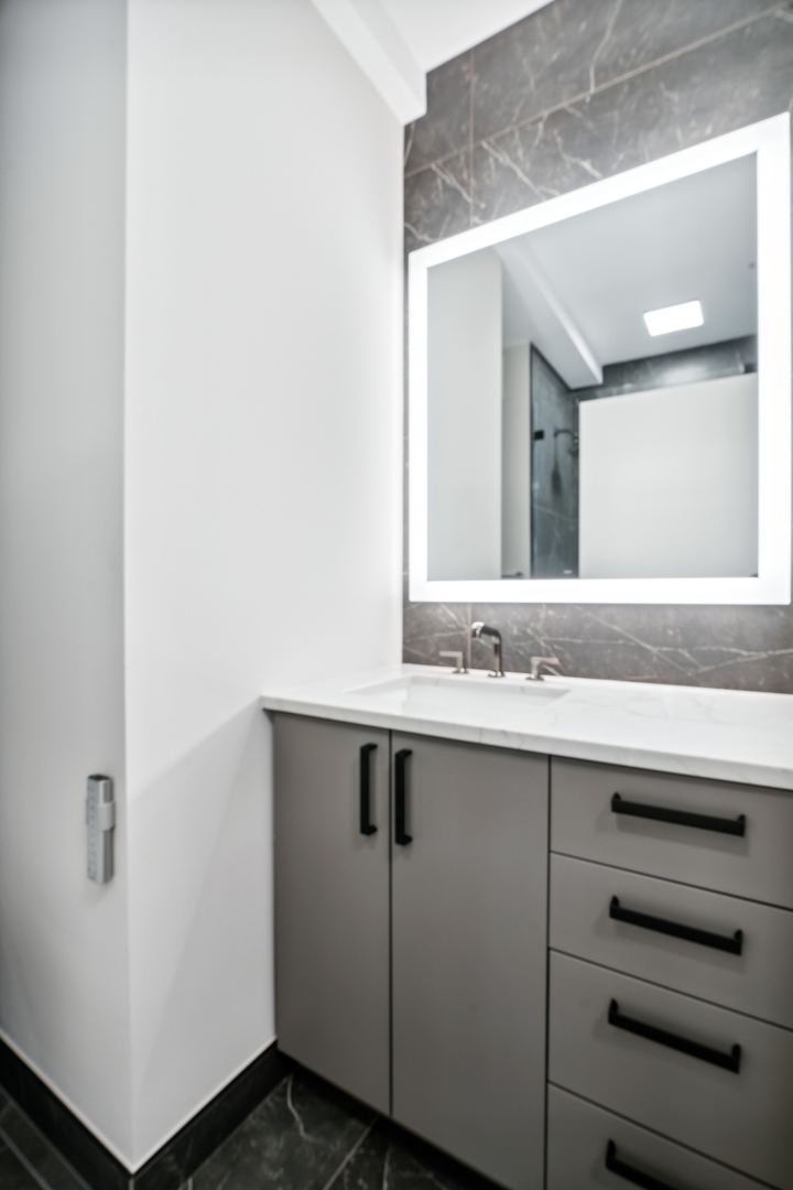 501 North Clinton Street, Unit 2004 Chicago, IL 60654 - Photo 23 of 34 a bathroom with a sink and a mirror