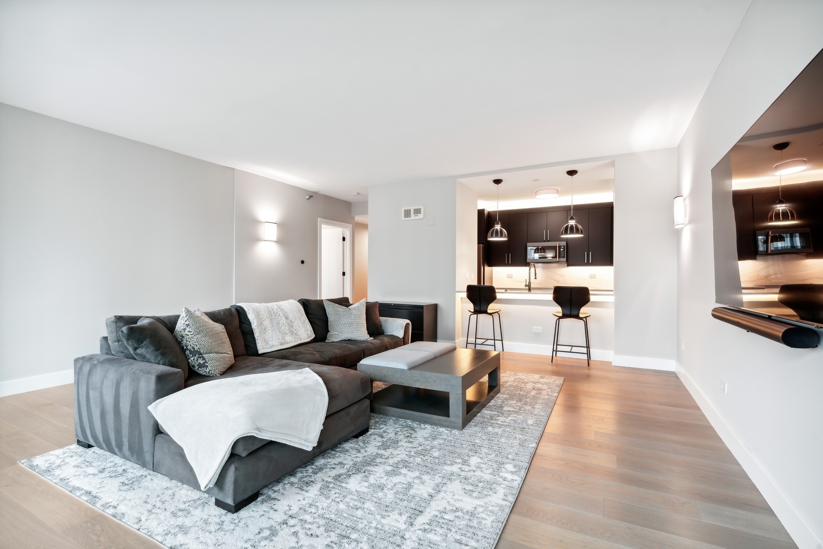 501 North Clinton Street, Unit 2004 Chicago, IL 60654 - Photo 6 of 34 a living room with furniture and view of kitchen