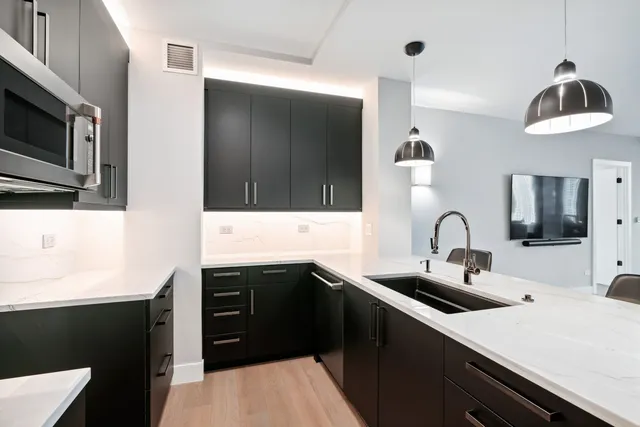 a kitchen with stainless steel appliances a sink a stove and a microwave
