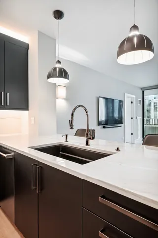 a kitchen with a sink and a refrigerator