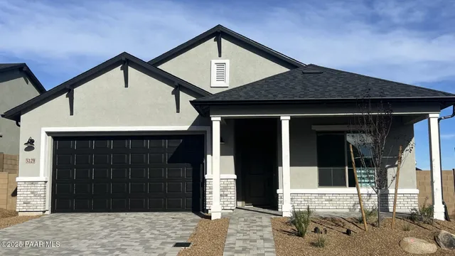 a front view of a house with a garage