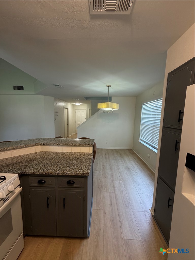 1316 Opal Road, Unit A Killeen, TX 76543 - Photo 9 of 25 a view of a kitchen counter top space with wooden floor