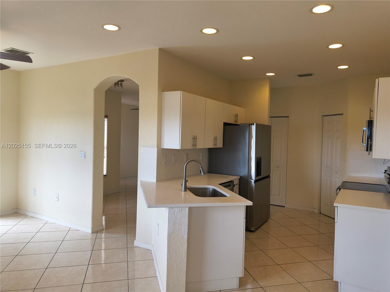 1645 Southeast 20th Road, Unit 1645 Homestead, FL 33035 - Photo 1 of 20 a kitchen with stainless steel appliances a refrigerator and a stove