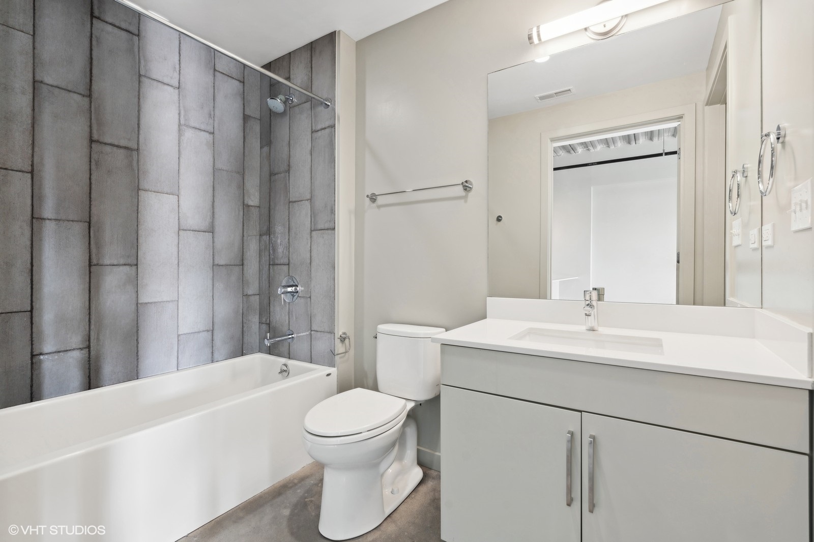 1241 North Milwaukee Avenue, Unit 306 Chicago, IL 60622 - Photo 13 of 14 a bathroom with a sink toilet vanity and shower