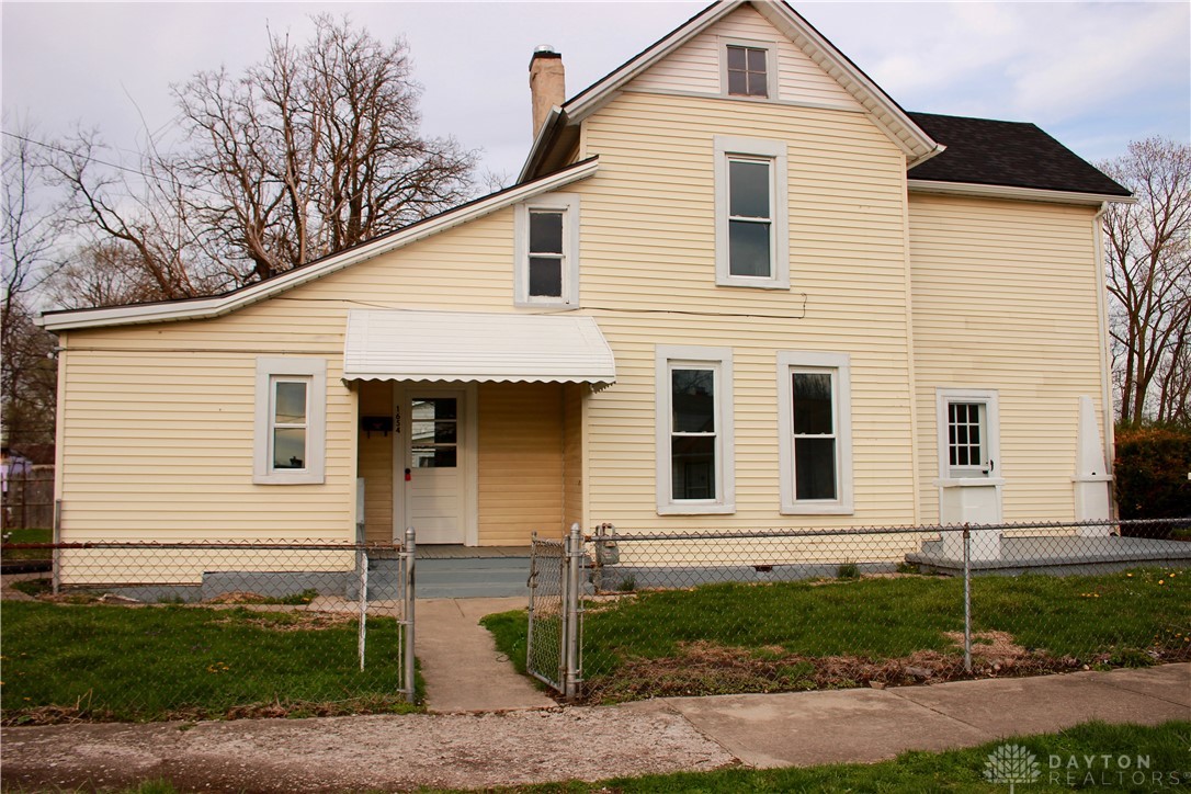 This charming home offers a traditional facade with classic siding and a welcoming porch.